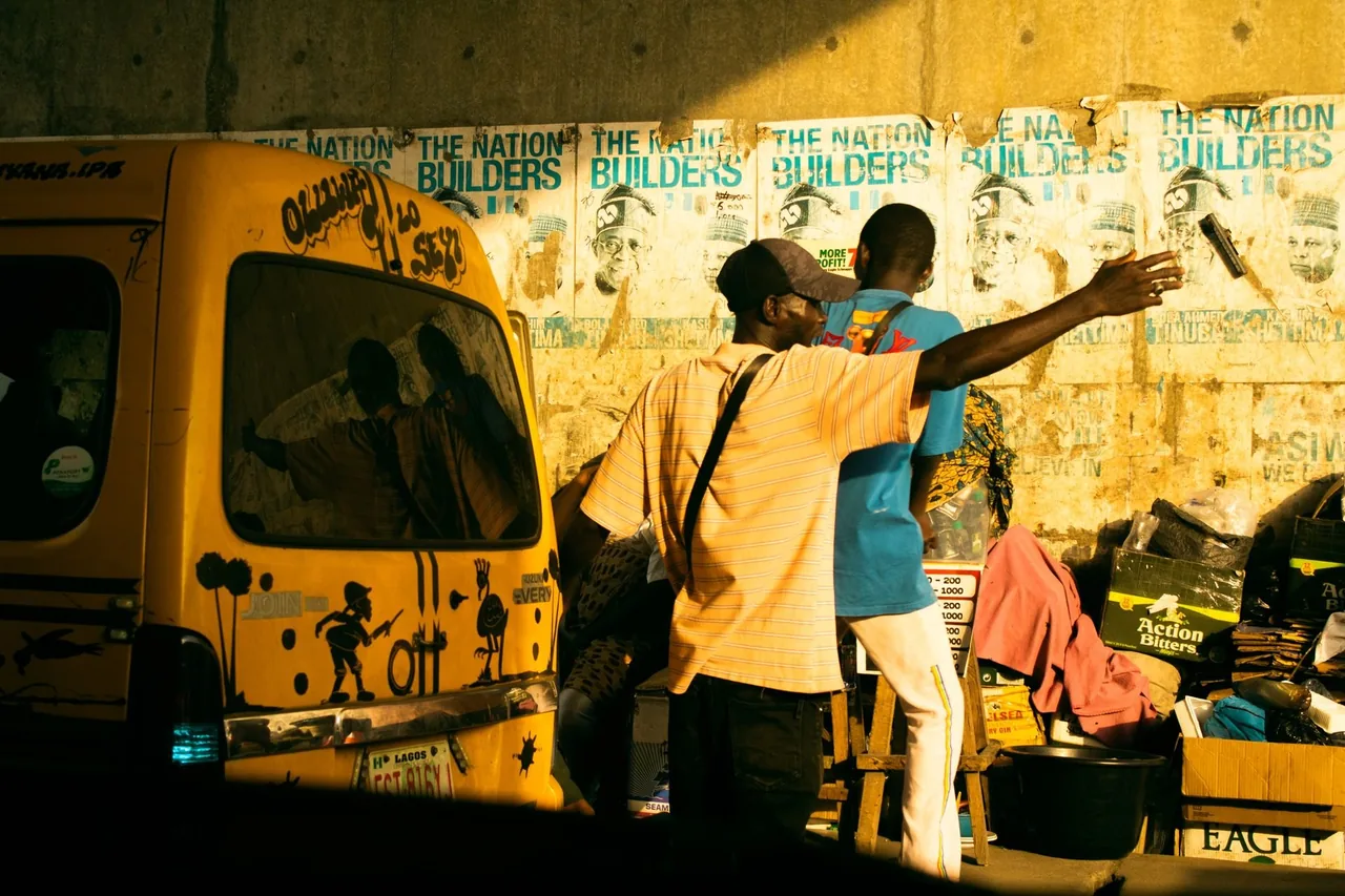 Yellow danfo minibus on a busy Lagos street at golden hour